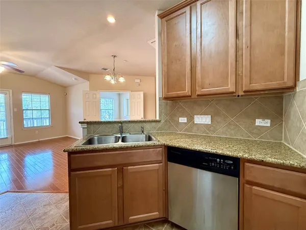 a kitchen with wooden cabinets and a stove top oven