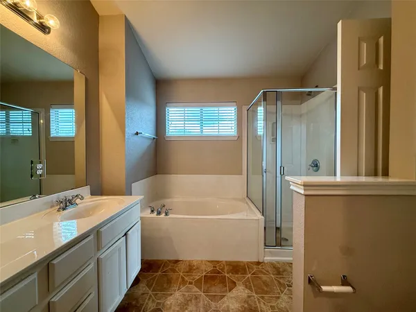a bathroom with a tub sink and a mirror
