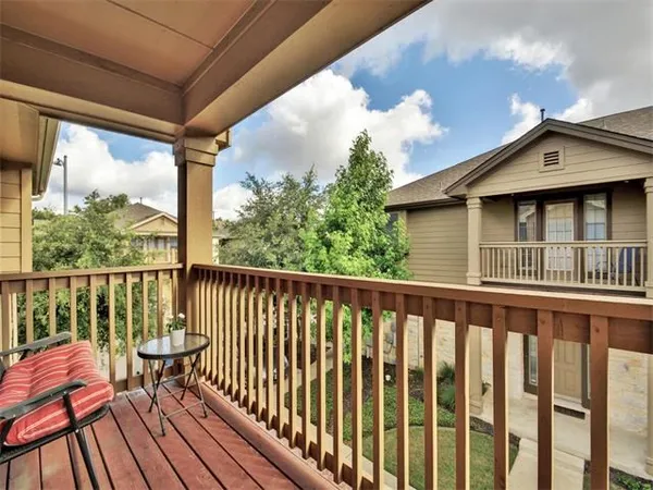a roof deck with wooden floor and fence