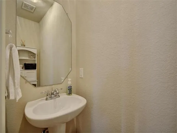 a view of a big room with wooden floor and a kitchen view