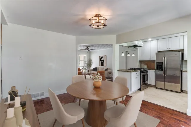 a kitchen with a dining table and chairs