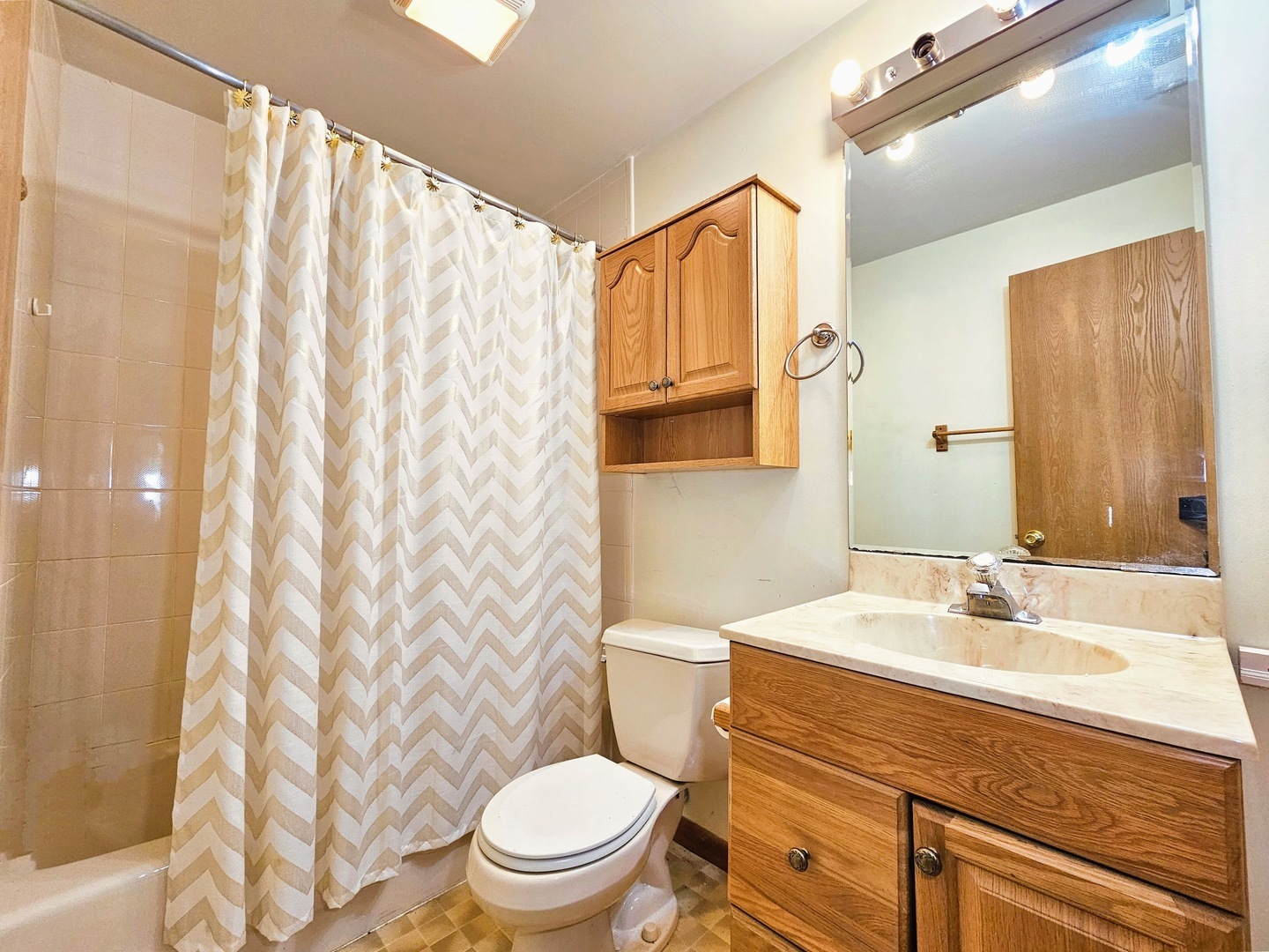 2434 Red Bud Court Aurora, IL 60502 - Photo 11 of 16 a bathroom with a sink a toilet and shower curtain