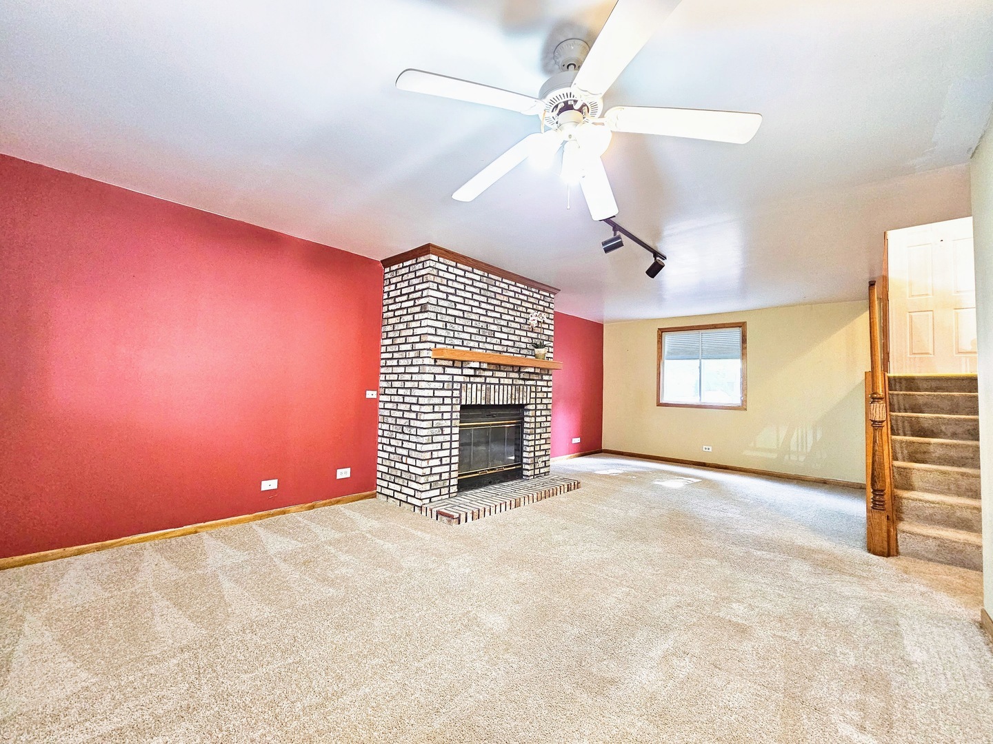 2434 Red Bud Court Aurora, IL 60502 - Photo 13 of 16 en empty room with windows and fireplace