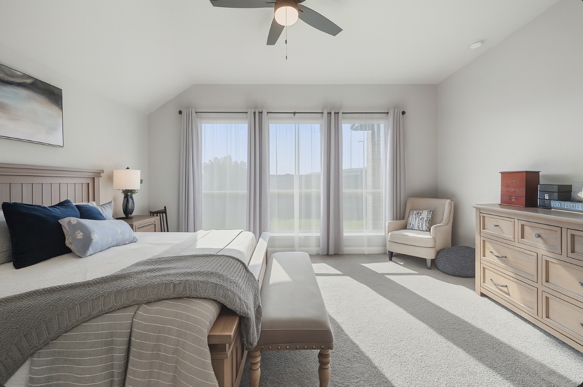 29726 Smoky Ridge Road Fulshear, TX 77441 - Photo 11 of 43 a bedroom with a large bed and a chandelier