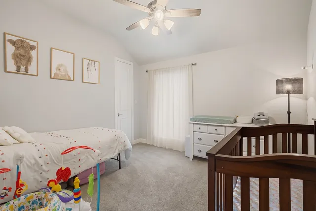 a bedroom with a bed and a baby crib