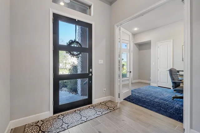 a view of livingroom and dining room with wooden floor