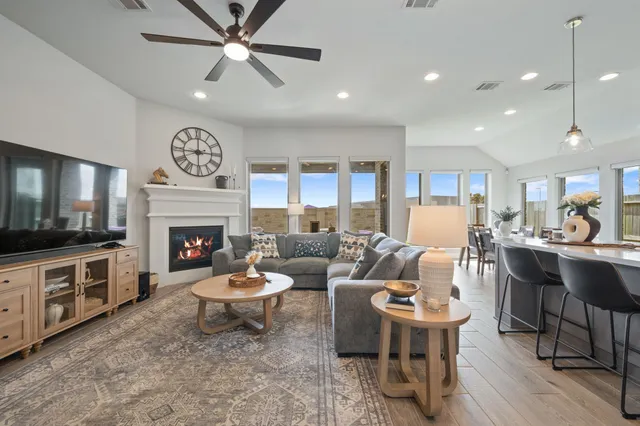a spacious bedroom with a bed and a chandelier