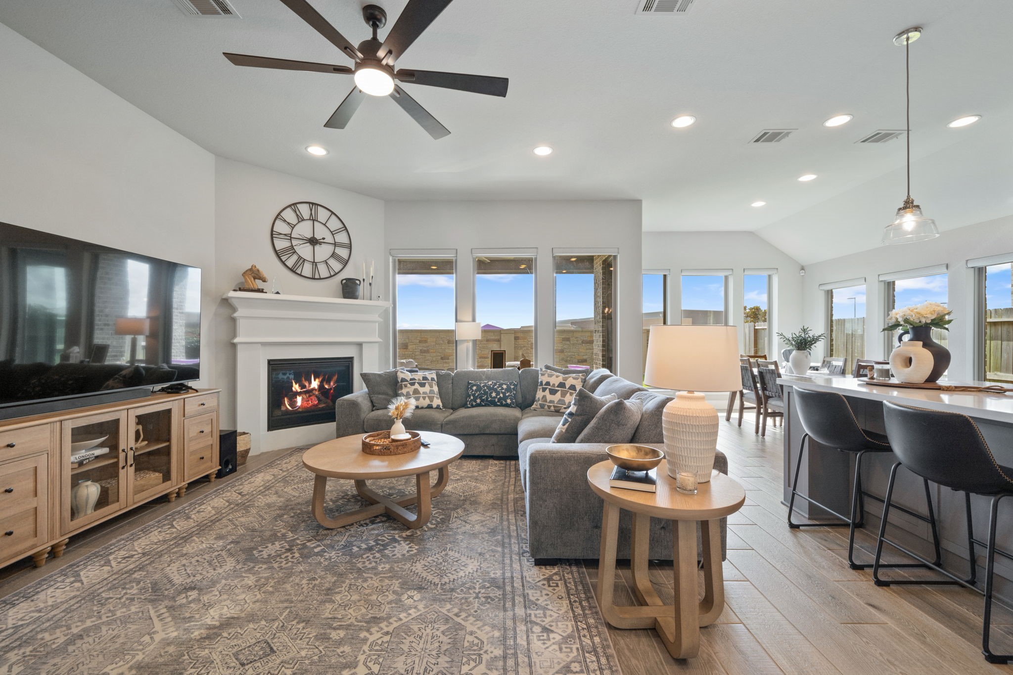 29726 Smoky Ridge Road Fulshear, TX 77441 - Photo 2 of 43 a living room with furniture a fireplace and a flat screen tv