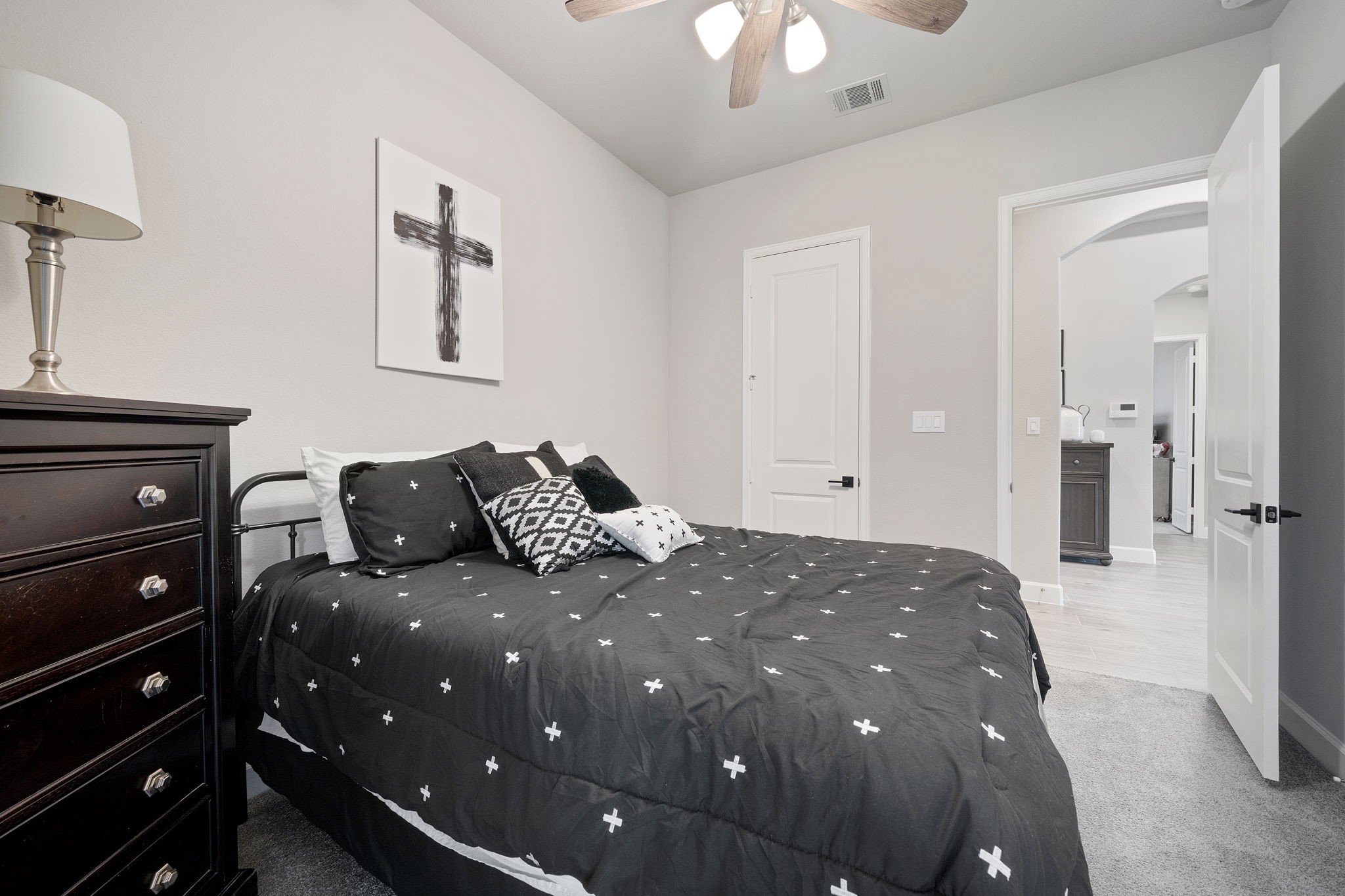 29726 Smoky Ridge Road Fulshear, TX 77441 - Photo 24 of 43 a bedroom with a bed and a chandelier