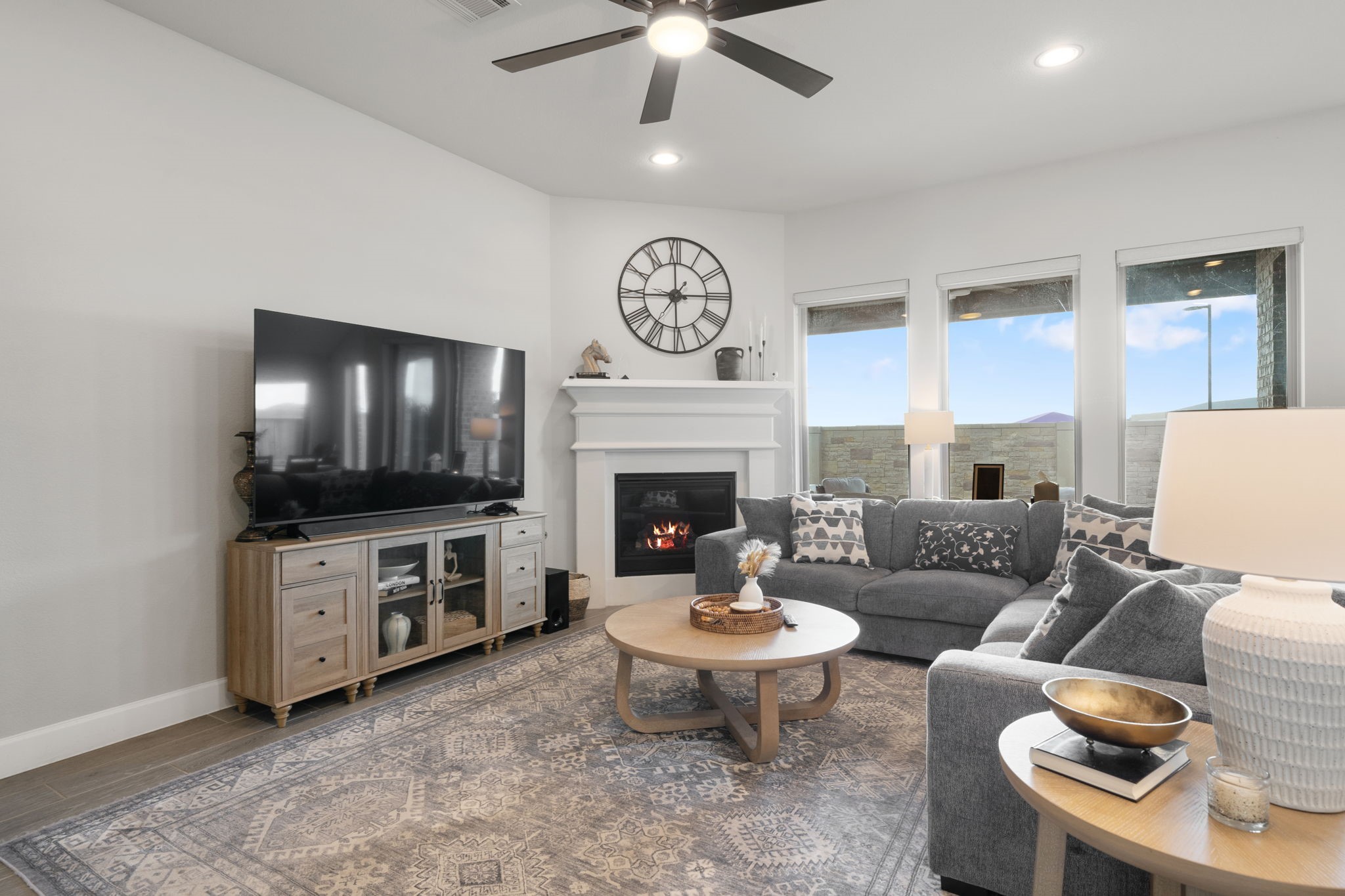 29726 Smoky Ridge Road Fulshear, TX 77441 - Photo 26 of 43 a living room with furniture a flat screen tv and a fireplace