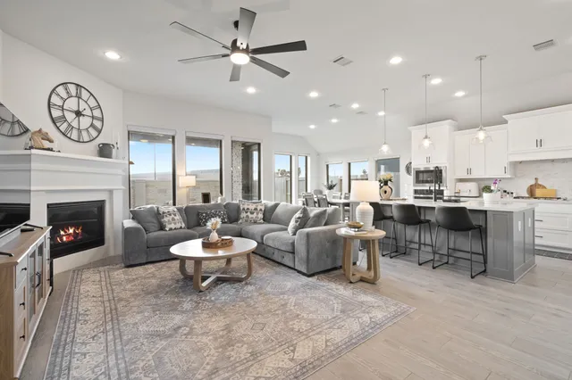 a living room with furniture a fireplace and a window