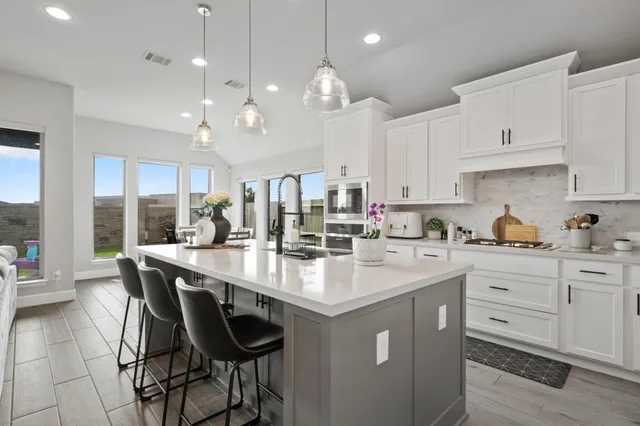 a kitchen with a dining table and chairs