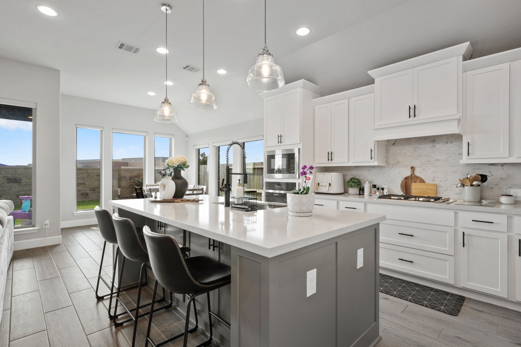 29726 Smoky Ridge Road Fulshear, TX 77441 - Photo 30 of 43 a kitchen with kitchen island granite countertop a sink a center island and cabinets