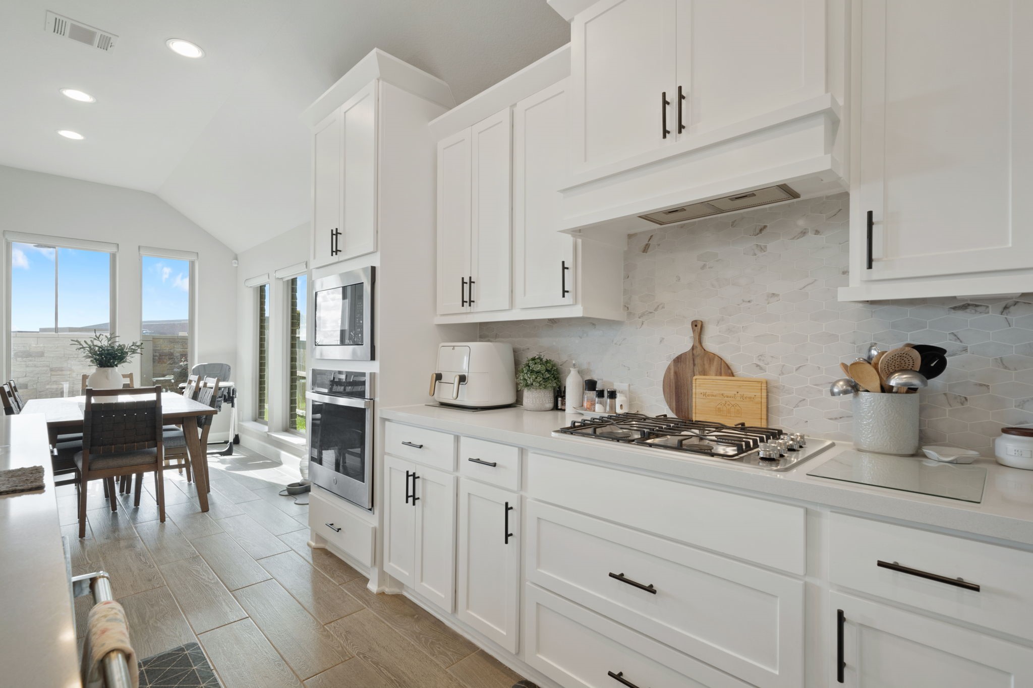 29726 Smoky Ridge Road Fulshear, TX 77441 - Photo 32 of 43 a kitchen with white cabinets and appliances