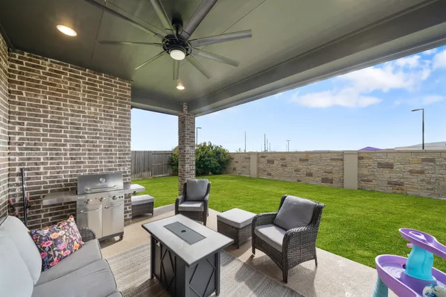 a view of a patio with couches table and chairs and potted plants