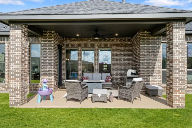 a view of a house with a yard and sitting area