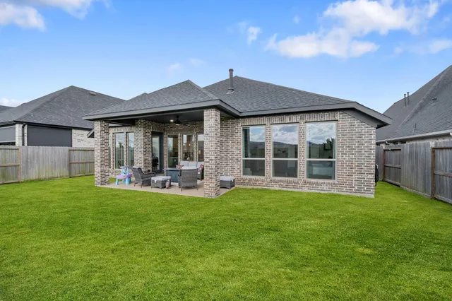 a view of a house with a yard and porch