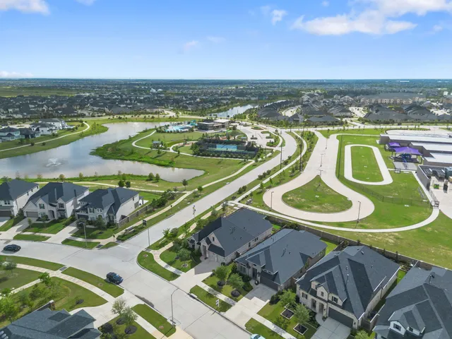 an aerial view of a house with outdoor space swimming pool and lake view