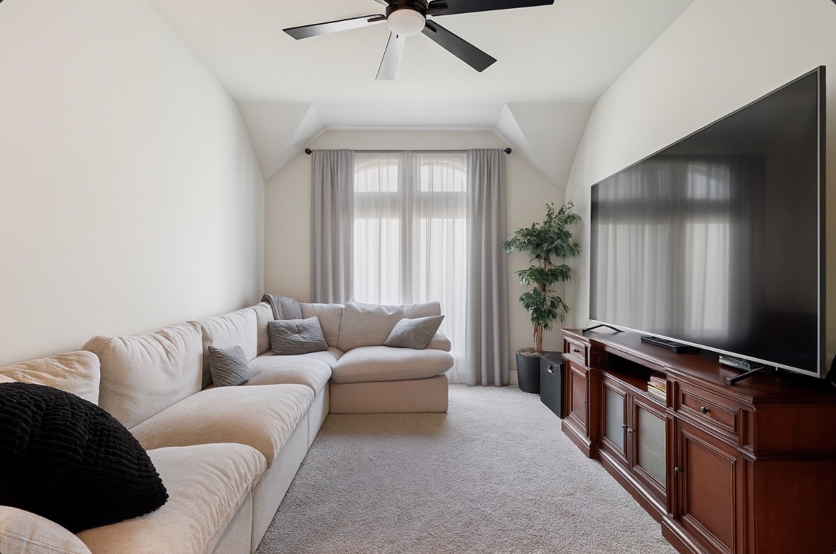 29726 Smoky Ridge Road Fulshear, TX 77441 - Photo 5 of 43 a living room with furniture and a flat screen tv
