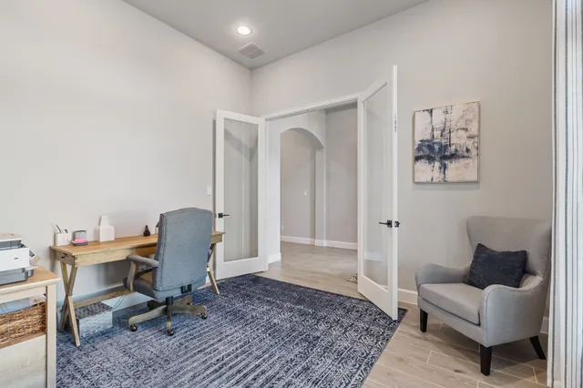 a white bath tub sitting next to a bathroom