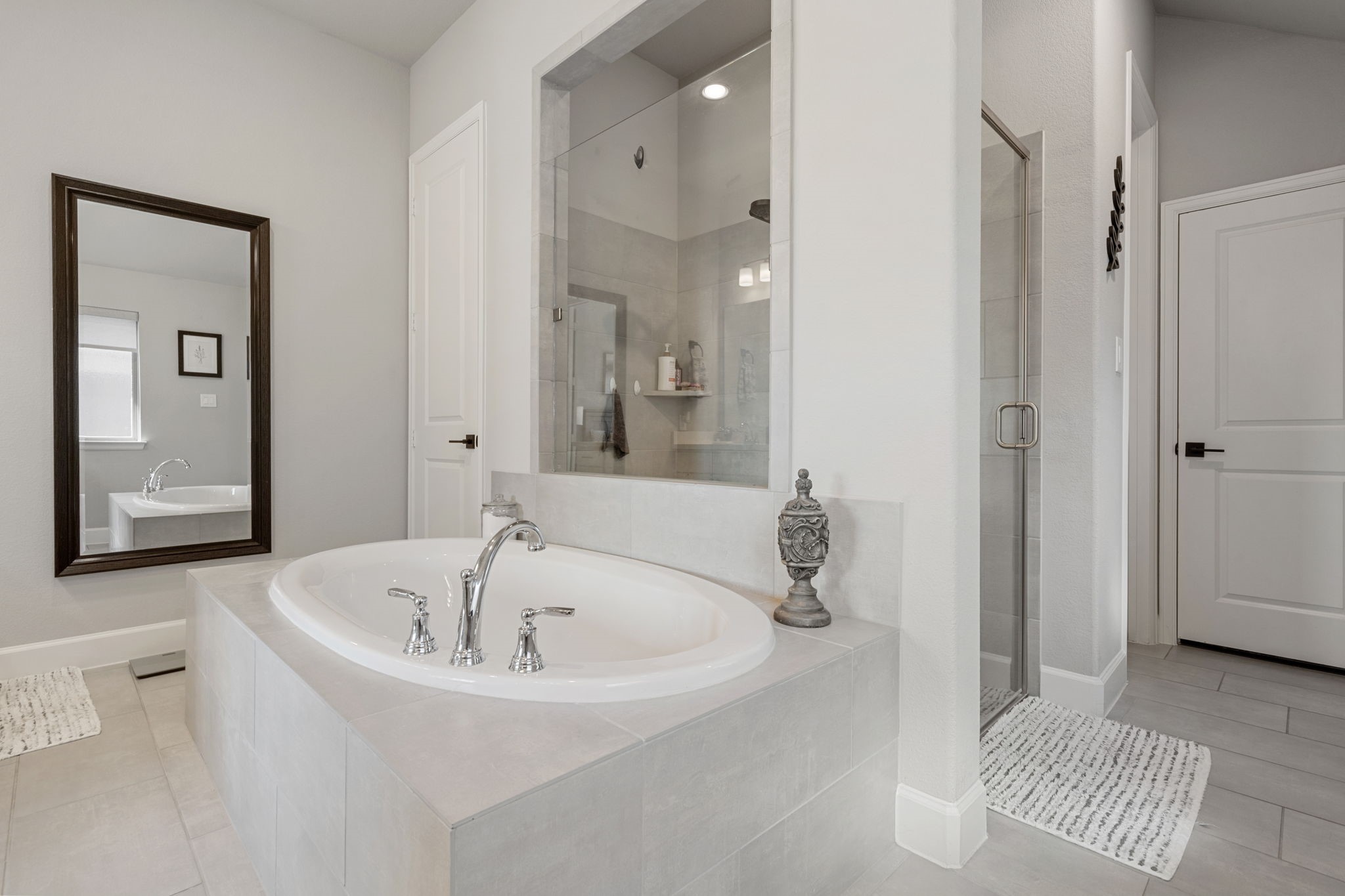 29726 Smoky Ridge Road Fulshear, TX 77441 - Photo 7 of 43 a white bath tub sitting next to a bathroom