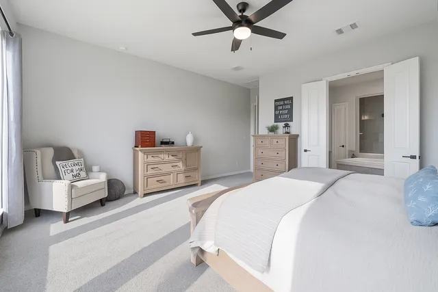a bedroom with a large bed and a chandelier