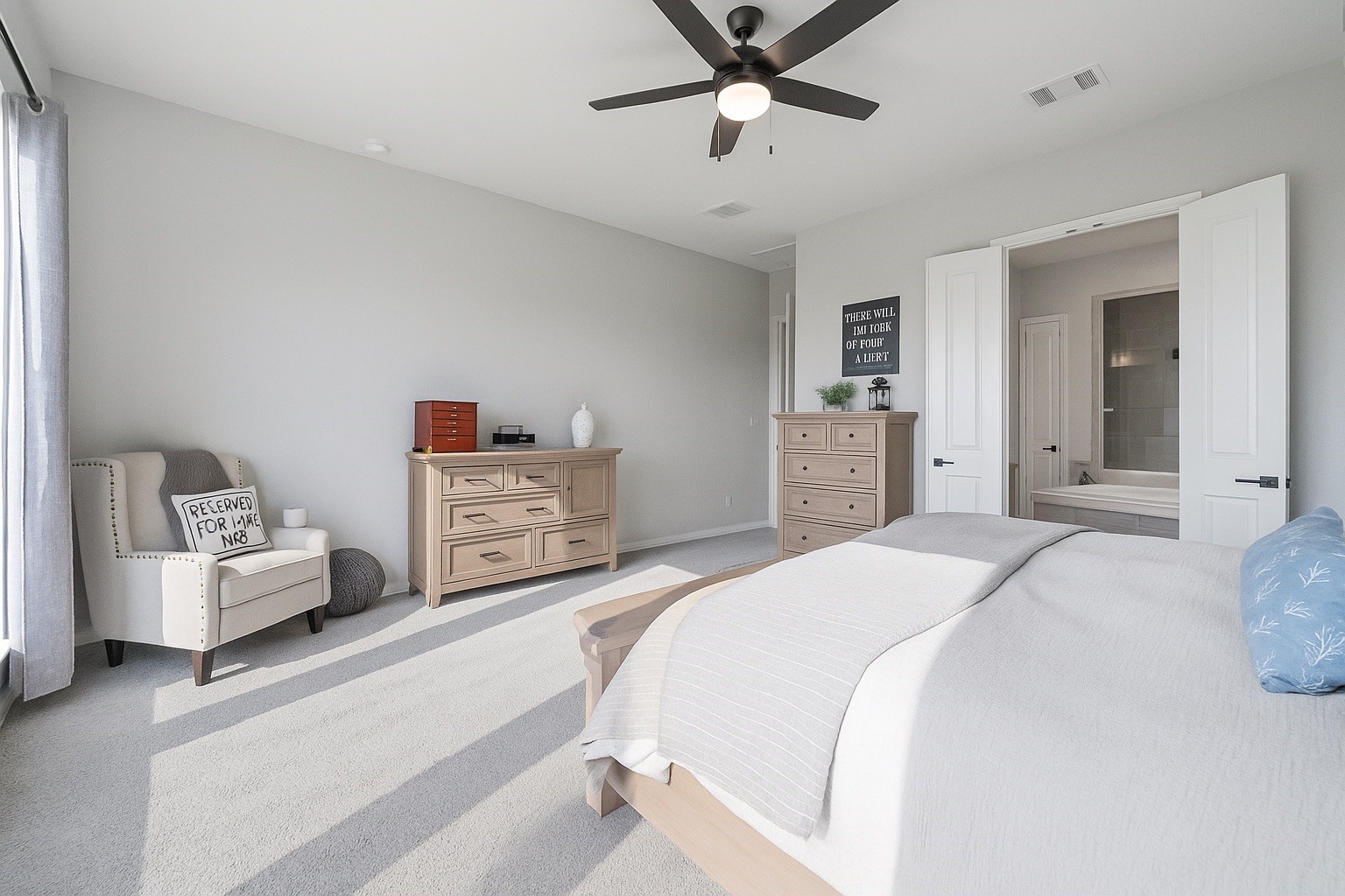 29726 Smoky Ridge Road Fulshear, TX 77441 - Photo 10 of 43 a spacious bedroom with a bed and a chandelier