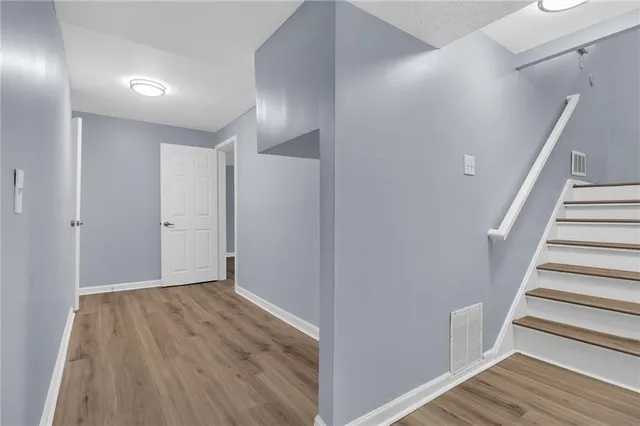 a view of hallway with wooden floor