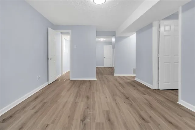 a view of a room with wooden floor