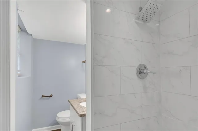 a white toilet sitting next to a bathroom sink