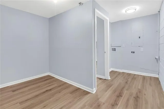 a view of a room with wooden floor