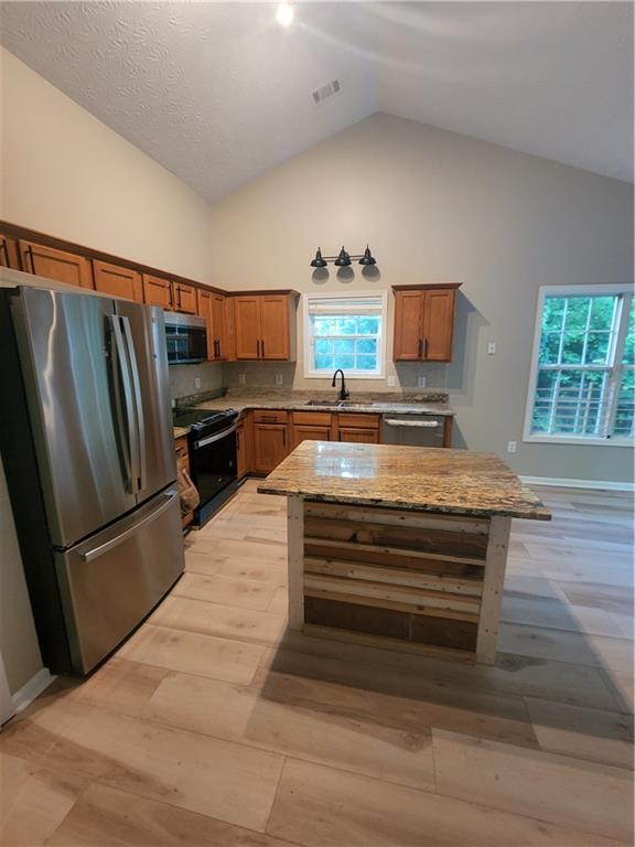 435 Butler Bridge Circle Covington, GA 30016 - Photo 21 of 25 a view of kitchen with refrigerator stove and microwave