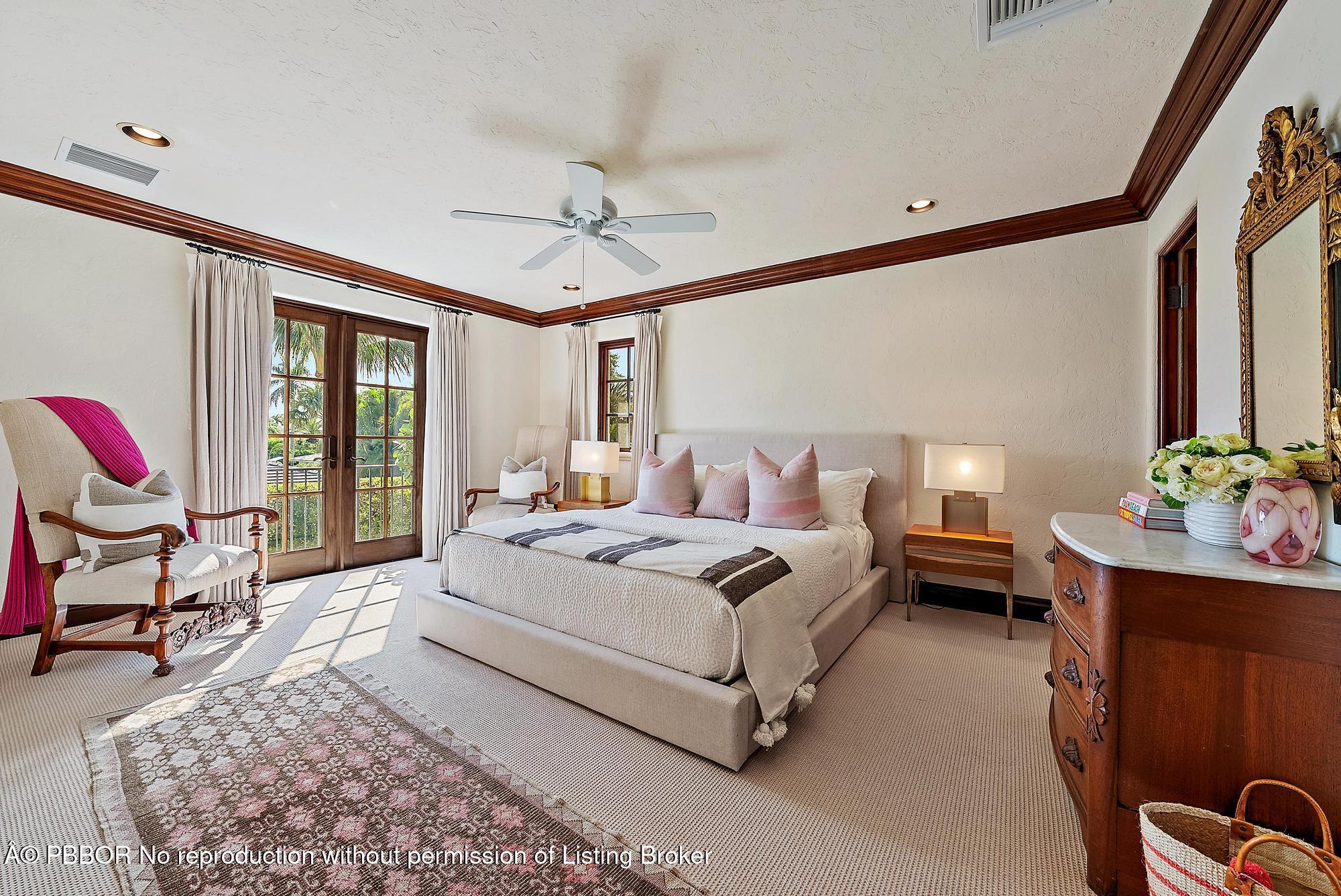234 Ridgeview Drive Palm Beach, FL 33480 - Photo 16 of 20 a spacious bedroom with a bed a chandelier and window