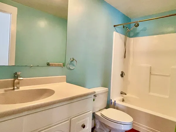 a kitchen with a sink and wooden floor