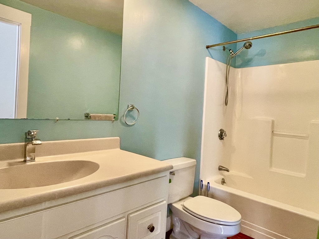 49 Munroe Street, Unit 201 Lynn, MA 01901 - Photo 14 of 16 a bathroom with a sink a toilet and shower