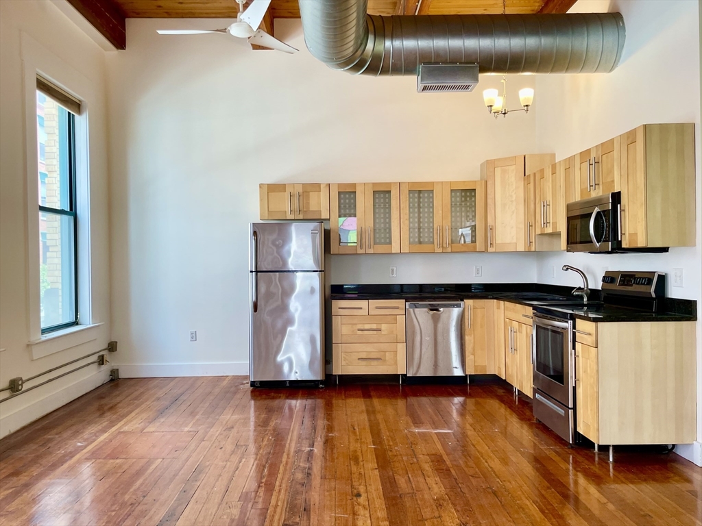 49 Munroe Street, Unit 201 Lynn, MA 01901 - Photo 16 of 16 a kitchen with a sink and wooden floor