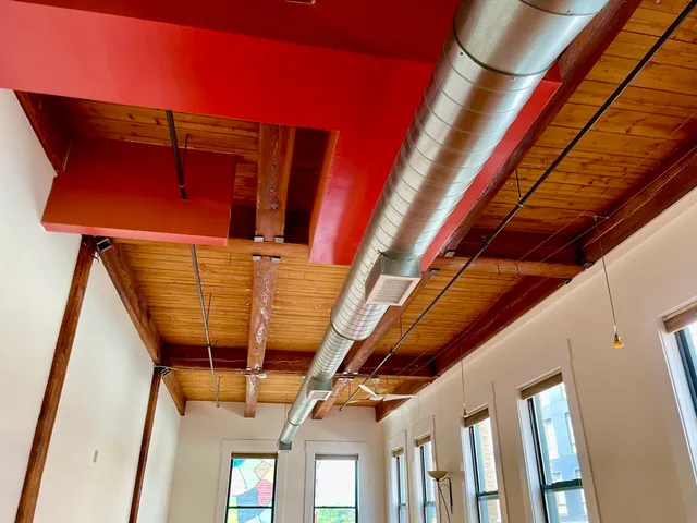a view of a room with wooden floor