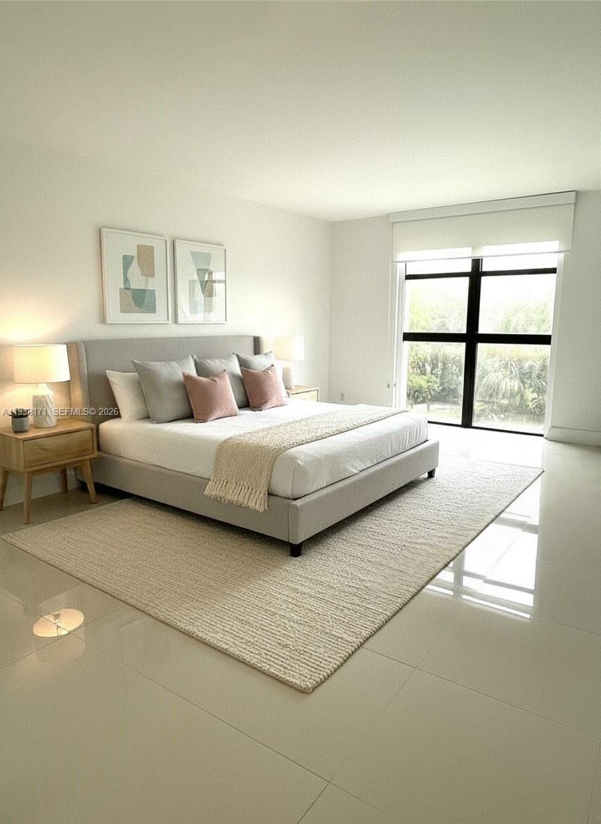 a bedroom with a bed and a large window