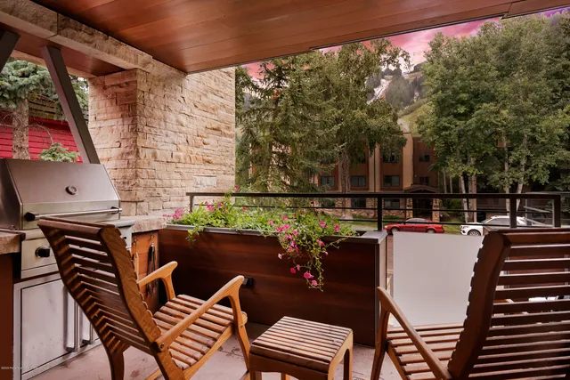 a balcony with table and chairs