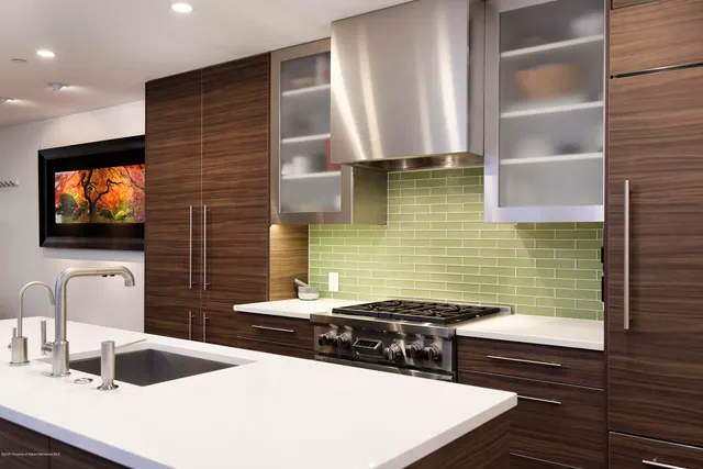 a kitchen with stainless steel appliances a stove a sink and a microwave