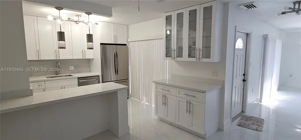 a kitchen with cabinets and stainless steel appliances