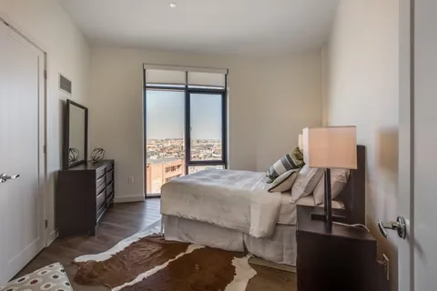 a bedroom with a bed and wooden floor