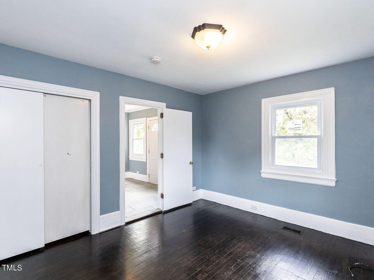 7 Ratcale Lane Durham, NC 27705 - Photo 14 of 33 an empty room with wooden floor and windows