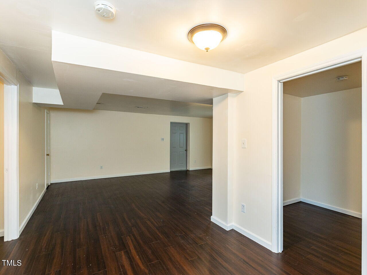 7 Ratcale Lane Durham, NC 27705 - Photo 23 of 33 an empty room with wooden floor and windows