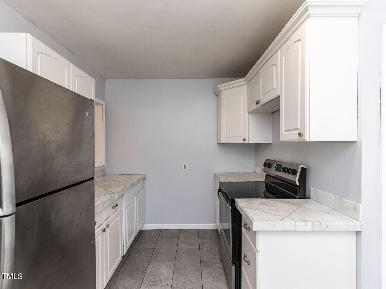 7 Ratcale Lane Durham, NC 27705 - Photo 9 of 33 a kitchen with stainless steel appliances white cabinets and a refrigerator