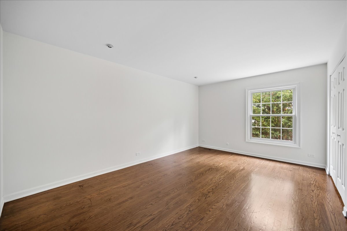 1701 Colonial Lane Northfield, IL 60093 - Photo 12 of 20 an empty room with wooden floor and windows