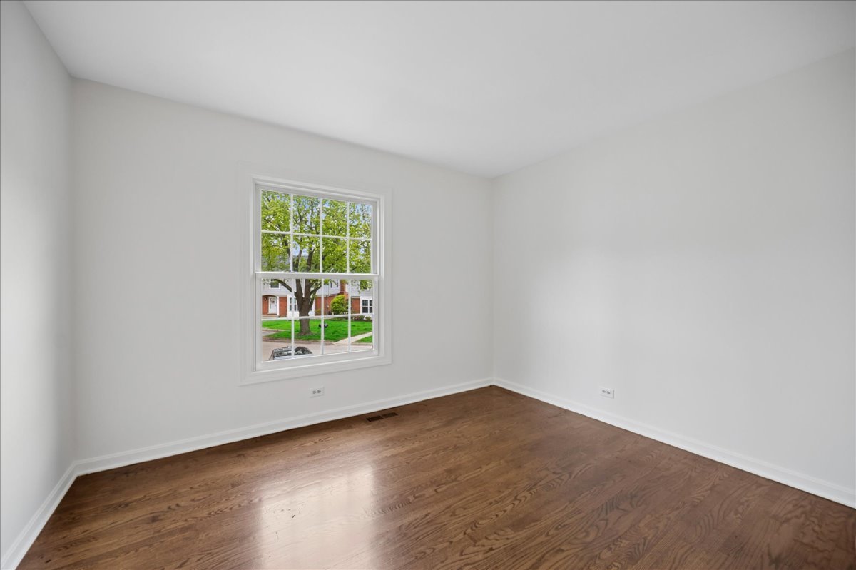 1701 Colonial Lane Northfield, IL 60093 - Photo 14 of 20 an empty room with wooden floor and windows