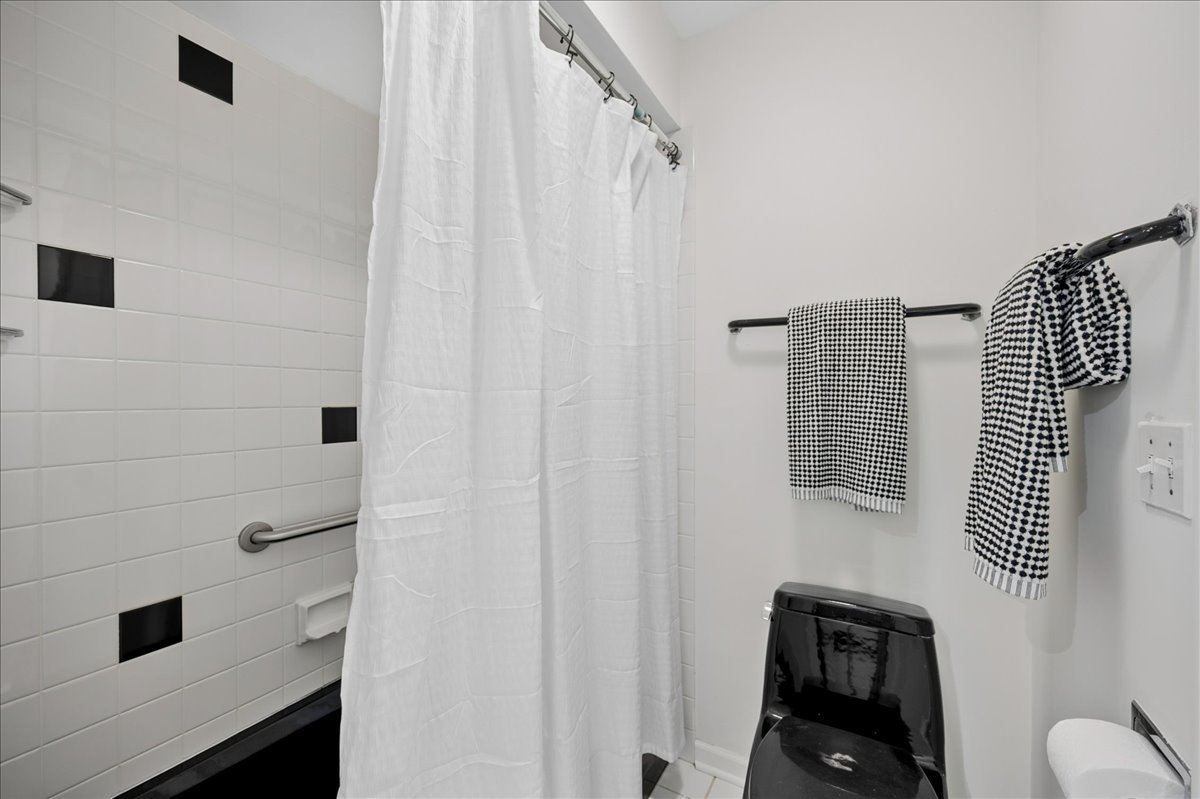 1701 Colonial Lane Northfield, IL 60093 - Photo 16 of 20 a bathroom with a shower curtain and a sink