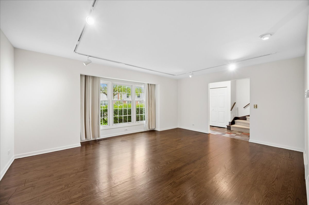 1701 Colonial Lane Northfield, IL 60093 - Photo 3 of 20 a view of an empty room with wooden floor and a window