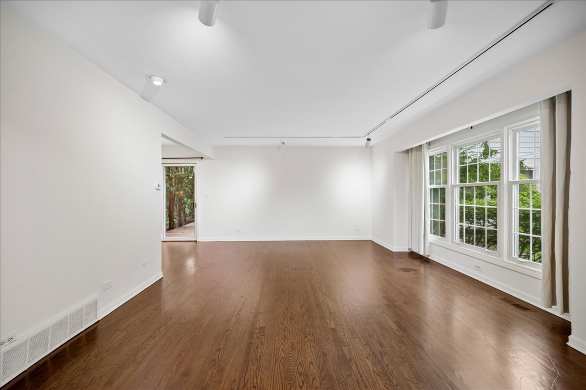 1701 Colonial Lane Northfield, IL 60093 - Photo 5 of 20 an empty room with wooden floor and windows